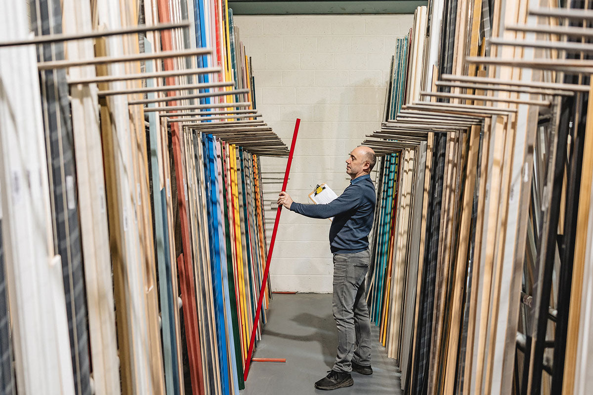 Men looking at wood mouldings in a warehouse